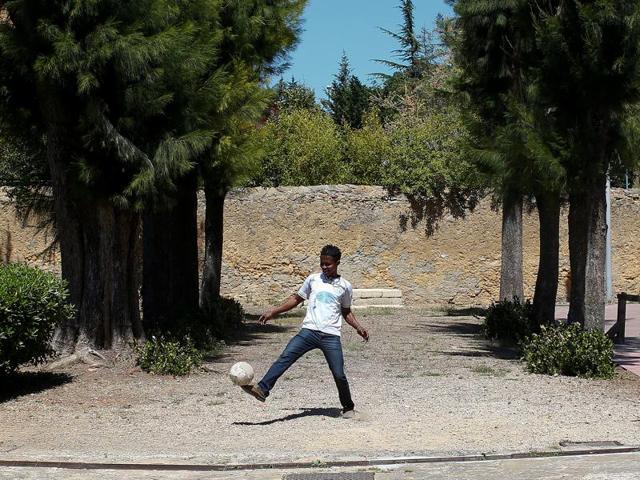 A migrant plays with a ball at an immigration centre in the Sicilian town of Caltagirone, Italy. (Reuters) A migrant plays with a ball at an immigration centre in the Sicilian town of Caltagirone, Italy. (Reuters)