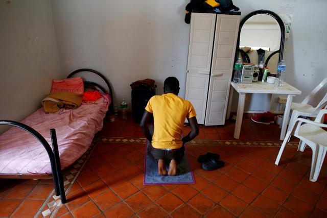 A migrant prays in his room at an immigration centre in Caltagirone, Italy, on April 22, 2016. (Reuters) A migrant prays in his room at an immigration centre in Caltagirone, Italy, on April 22, 2016. (Reuters)