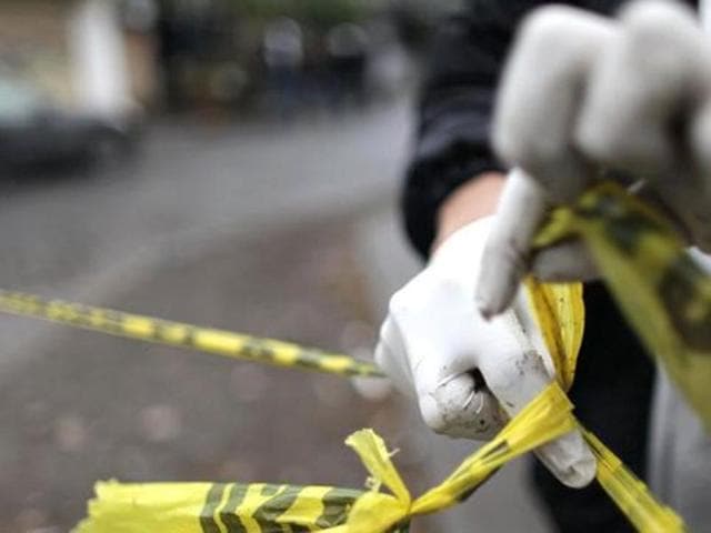 A forensic technician ties a used police line together to seal off a crime scene.(Representational Image: Reuters)