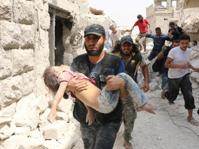 A Syrian man carries a wounded child following a barrel bomb attack on the Bab al-Nairab neighbourhood of the northern Syrian city of Aleppo on Thursday. (AFP) A Syrian man carries a wounded child following a barrel bomb attack on the Bab al-Nairab neighbourhood of the northern Syrian city of Aleppo on Thursday. (AFP)