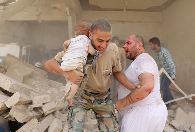 A Syrian man carries a wounded child following a barrel bomb attack on the Bab al-Nairab neighbourhood of the northern Syrian city of Aleppo on Thursday. (AFP) A Syrian man carries a wounded child following a barrel bomb attack on the Bab al-Nairab neighbourhood of the northern Syrian city of Aleppo on Thursday. (AFP)