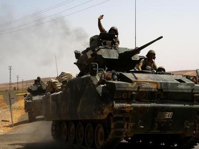A Turkish soldier on an armoured personnel carrier waves as they drive from the border back to their base in Karkamis on the Turkish-Syrian border in the southeastern Gaziantep province, Turkey. (Reuters) A Turkish soldier on an armoured personnel carrier waves as they drive from the border back to their base in Karkamis on the Turkish-Syrian border in the southeastern Gaziantep province, Turkey. (Reuters)