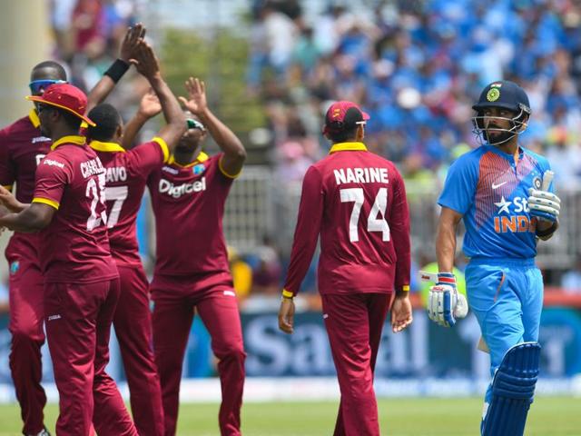 Virat Kohli (R) of India walks off the field dismissed by Dwayne Bravo. (AFP Photo) Virat Kohli (R) of India walks off the field dismissed by Dwayne Bravo. (AFP Photo)