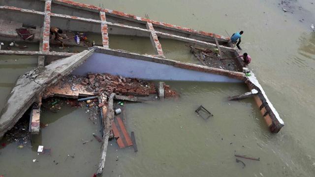 A building collapses in flood waters at Chapra in Saran district of Bihar. (PTI Photo) A building collapses in flood waters at Chapra in Saran district of Bihar. (PTI Photo)