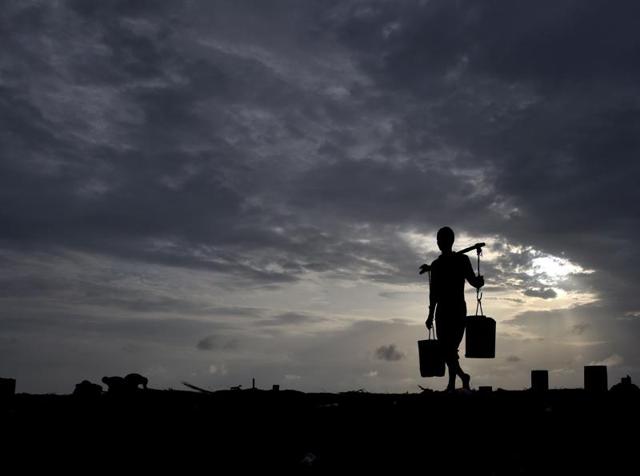 Versova in Mumbai has been witnessing fenugreek farming for years, with some families doing the job for as long as 60 years.  Currently, 30-40 farmers  grow fenugreek along the beach.  (In pic) A farmer carries water from a well dug in sea sand on Tuesday. (Pratham Gokhale) 