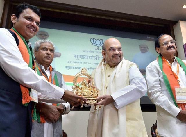 Maharashtra CM Devendra Fadnavis presents an idol of Lord Ganesha to BJP president Amit Shah as Union minister Venkaiah Naidu looks on during the party’s CMs meeting at Maharashtra Sadan in New Delhi on Saturday. (PTI) Maharashtra CM Devendra Fadnavis presents an idol of Lord Ganesha to BJP president Amit Shah as Union minister Venkaiah Naidu looks on during the party’s CMs meeting at Maharashtra Sadan in New Delhi on Saturday. (PTI)