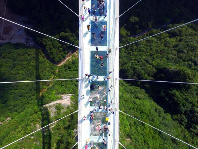 A glass-floor suspension bridge in Zhangjiajie in southern China's Hunan Province opened to the public on a trial basis recently.  (AP) 