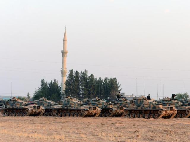 Turkish tanks stationed in Karkamis, Turkey, near the Syrian border on Saturday. (AP) Turkish tanks stationed in Karkamis, Turkey, near the Syrian border on Saturday. (AP)
