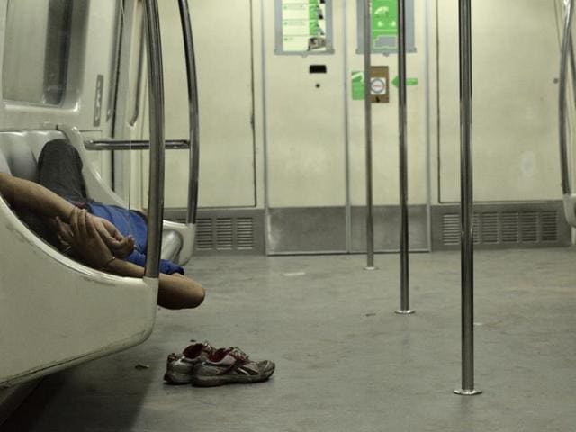 A commuter asleep on the last train on the Blue Line, which runs from Dwarka to Vaishali in New Delhi on Monday. (arun sharma/ht) 