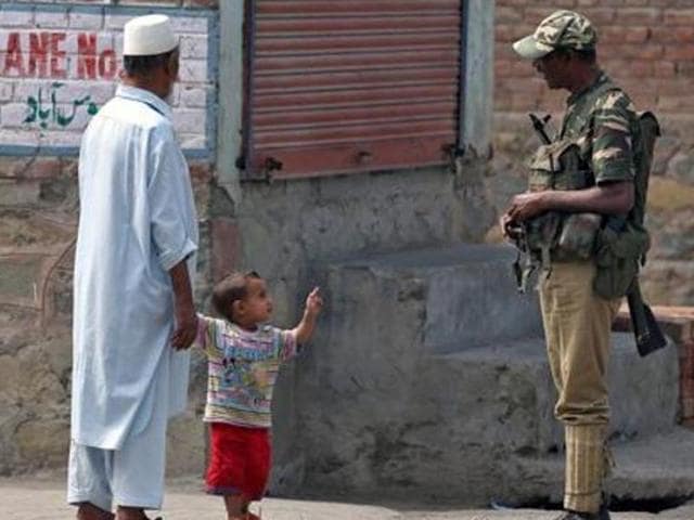 A boy gestures at a member of the security forces in Srinagar.(Reuters) A boy gestures at a member of the security forces in Srinagar.(Reuters)