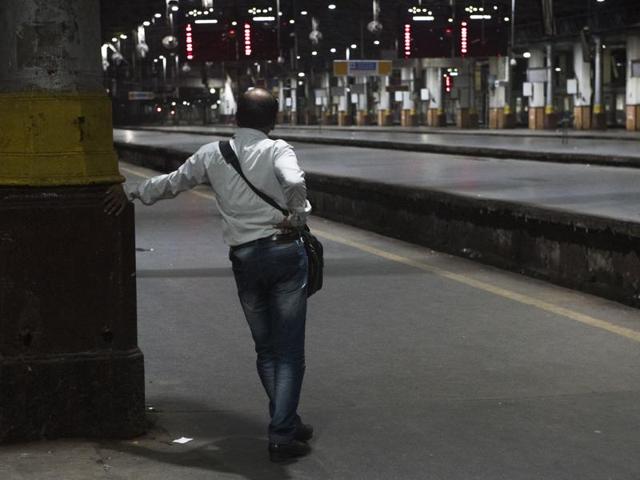 Commuters wait for the 12:30am Karjat last local train to arrive at the Chhatrapati Shivaji Terminus railway station in Mumbai on Thursday. Bouncers, transgenders, policemen and small-time actors are the regular commuters on the last train. Years ago, missing the last train would mean the long wait till morning for the first train. Not anymore.  (Pratik Chorge/ht) 