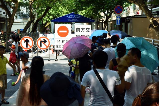 People move through a security check at the West Lake scenic spot in Hangzou, east China's Zhejiang province. Security has been enhanced ahead of the G20 Leaders Summit in Hangzhou. (AFP) People move through a security check at the West Lake scenic spot in Hangzou, east China's Zhejiang province. Security has been enhanced ahead of the G20 Leaders Summit in Hangzhou. (AFP)