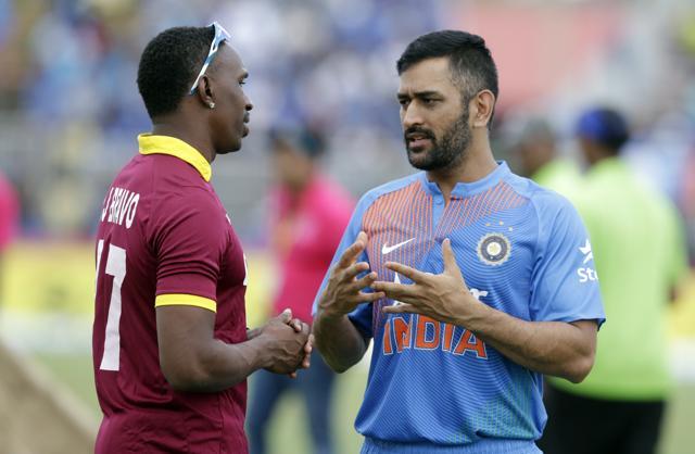 West Indies' Dwayne Bravo, left, and MS Dhoni, right, talk during a rain delay at the second Twenty20 international cricket match, Sunday. (AP) West Indies' Dwayne Bravo, left, and MS Dhoni, right, talk during a rain delay at the second Twenty20 international cricket match, Sunday. (AP)
