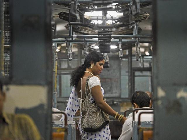 A transgender woman asks commuters inside the last local train for alms in Mumbai on Thursday. (Pratik Chorge/HT ) 