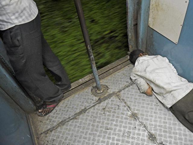 A man sleeping near the door of the Karjat last local train in Mumbai on Thursday. (Pratik Chorge/HT) 