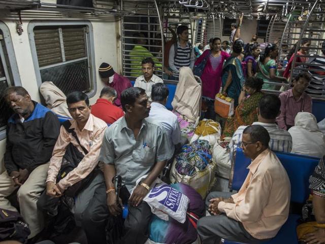 A crowd slowly assembles inside the first local train from Karjat to Mumbai on Saturday. (Pratik Chorge/HT ) 