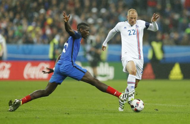 Iceland's Eidur Gudjohnsen in action with France's Paul Pogba. (REUTERS) Iceland's Eidur Gudjohnsen in action with France's Paul Pogba. (REUTERS)