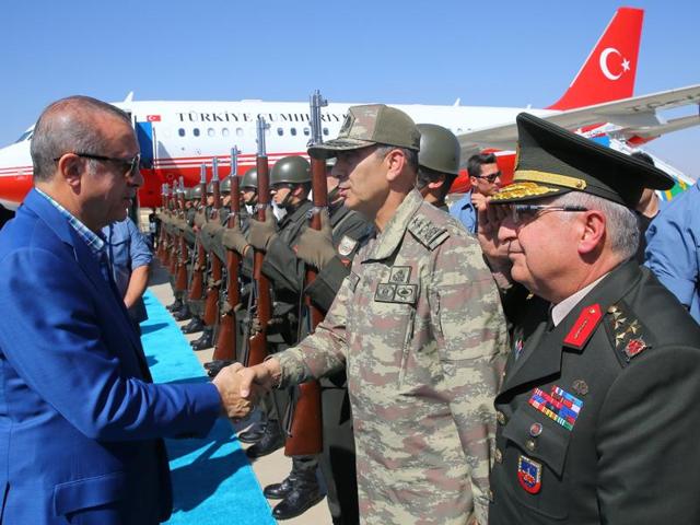 Turkish President Recep Tayyip Erdogan (left) shakes hands with a Turkish general after arriving at Gaziantep airport on Sunday. Erdogan has vowed to devote equal energy to combating Islamic State jihadists and Syrian Kurdish fighters, on the fifth day of a major offensive that has left dozens dead. (AFP) Turkish President Recep Tayyip Erdogan (left) shakes hands with a Turkish general after arriving at Gaziantep airport on Sunday. Erdogan has vowed to devote equal energy to combating Islamic State jihadists and Syrian Kurdish fighters, on the fifth day of a major offensive that has left dozens dead. (AFP)