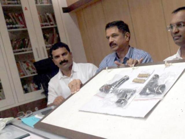 Pune crime branch officials show three pistols seized from a 50-year-old woman on Friday.(HT photo)