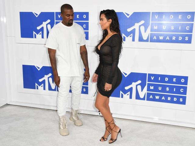 Kim Kardashian and Kanye West arrive for the 2016 MTV Video Music Awards as Kanye looks at his wife, (AFP) Kim Kardashian and Kanye West arrive for the 2016 MTV Video Music Awards as Kanye looks at his wife, (AFP)