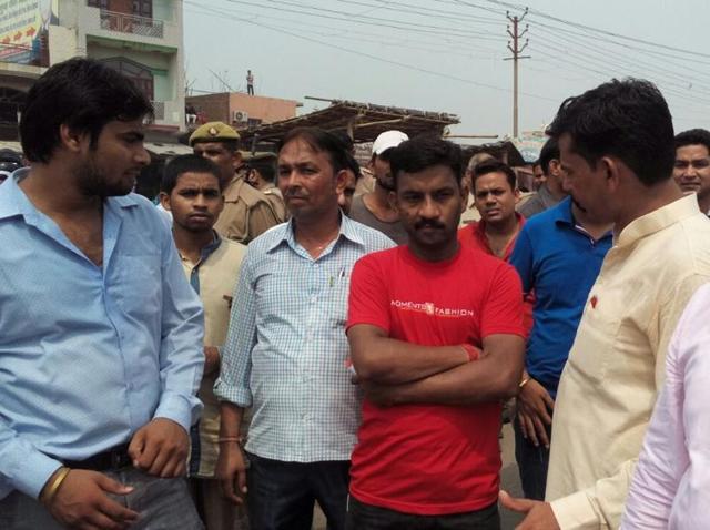 Locals gather in protest after the body of a one-year-old was found at the railway tracks near Loni railway station on Monday. (HT Photo) Locals gather in protest after the body of a one-year-old was found at the railway tracks near Loni railway station on Monday. (HT Photo)