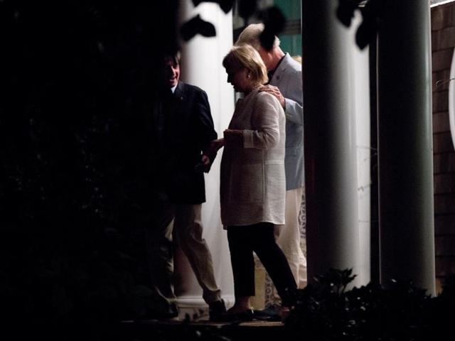 Democratic presidential candidate Hillary Clinton, second from left, and former President Bill Clinton, right, accompanied by Democratic Party activist Jay Snyder, left, leave a fundraiser at Snyder's home in East Hampton, N.Y.(AP Photo)