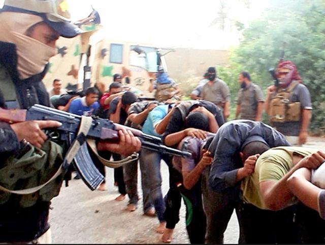 This image posted online by Islamic State militants on June 14, 2014 shows Iraqi cadets captured by IS moments before they were killed in Tikrit, Iraq. Their bodies are believed to be in one of the many mass graves left behind by Islamic State extremists. (AP) This image posted online by Islamic State militants on June 14, 2014 shows Iraqi cadets captured by IS moments before they were killed in Tikrit, Iraq. Their bodies are believed to be in one of the many mass graves left behind by Islamic State extremists. (AP)