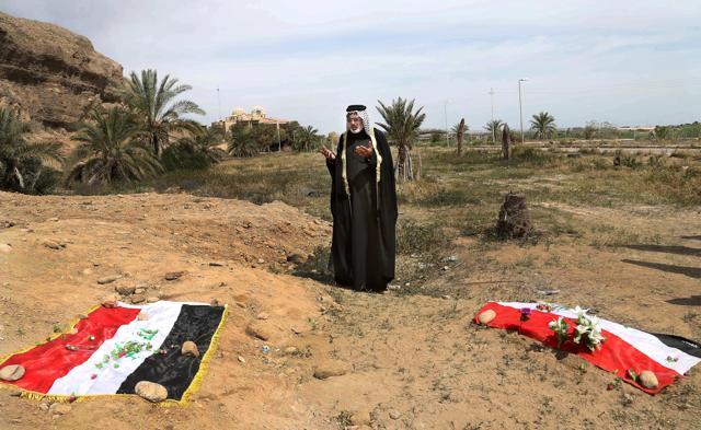 In this April 3, 2015, file photo, an Iraqi man prays for his slain relative at the site of a mass grave believed to contain the bodies of Iraqi soldiers killed by Islamic State group militants when they overran Camp Speicher military base in Tikrit, Iraq, in June 2014. (AP) In this April 3, 2015, file photo, an Iraqi man prays for his slain relative at the site of a mass grave believed to contain the bodies of Iraqi soldiers killed by Islamic State group militants when they overran Camp Speicher military base in Tikrit, Iraq, in June 2014. (AP)