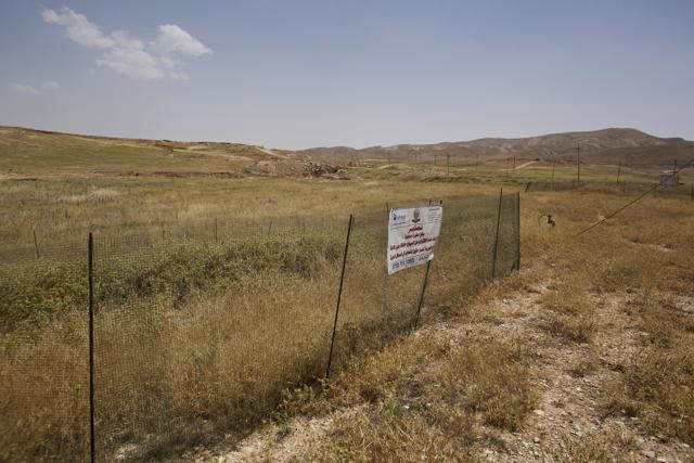 In this May 19, 2016 photo, the site where dozens of Yazidi men were killed in August 2014 is fenced off in Hardan, northern Iraq. (AP) In this May 19, 2016 photo, the site where dozens of Yazidi men were killed in August 2014 is fenced off in Hardan, northern Iraq. (AP)
