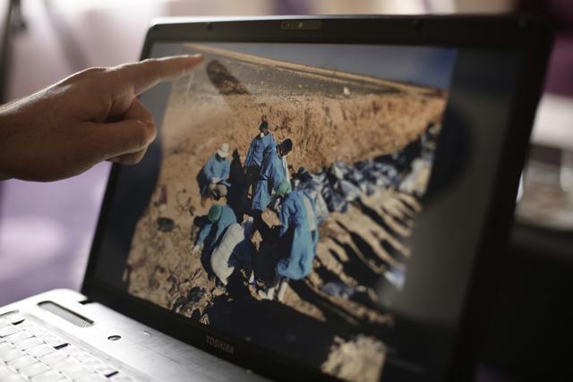 In this May 17, 2016 photo, Sirwan Jalal, Director of Mass Graves for the Kurdish Regional Government, points to an image of the site of a mass grave during an interview with the Associated Press in Irbil, northern Iraq. (AP) In this May 17, 2016 photo, Sirwan Jalal, Director of Mass Graves for the Kurdish Regional Government, points to an image of the site of a mass grave during an interview with the Associated Press in Irbil, northern Iraq. (AP)