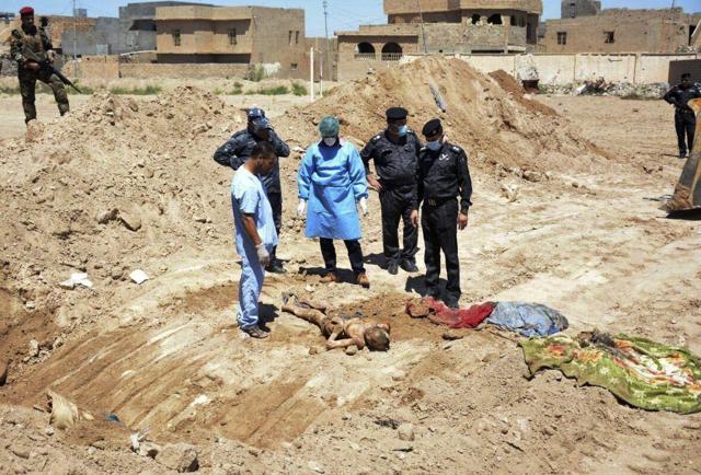In this April 19, 2016 file photo, an Iraqi security forces forensic team works at the site of a mass grave believed to contain the bodies of Iraqi civilians, security forces and members of their families, including women and children, killed by Islamic State group militants at the stadium area in Ramadi, Iraq. (AP) In this April 19, 2016 file photo, an Iraqi security forces forensic team works at the site of a mass grave believed to contain the bodies of Iraqi civilians, security forces and members of their families, including women and children, killed by Islamic State group militants at the stadium area in Ramadi, Iraq. (AP)