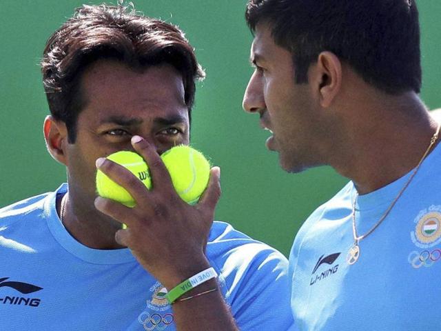Leander Paes, of India, blocks his face with tennis balls as he talks with his partner Rohan Bopanna. (AP Photo) Leander Paes, of India, blocks his face with tennis balls as he talks with his partner Rohan Bopanna. (AP Photo)