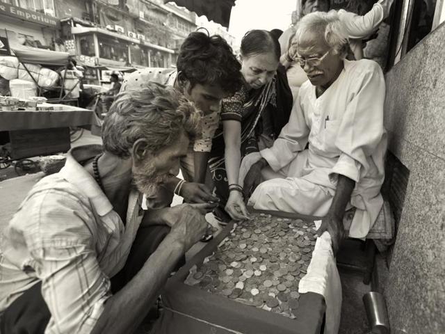 Chandni Chowk in Old Delhi is crowded, chaotic and filled with history . It’s a tourist attraction and for coin collectors a Mecca . Antique coin seller Sukh Ram Tiwari, 74, has been serving collectors in Chandni Chowk for the last four decades. Tiwari earns about Rs 200 everyday by selling coins. (Virendra Singh Gosain/HT PHOTO) Chandni Chowk in Old Delhi is crowded, chaotic and filled with history . It’s a tourist attraction and for coin collectors a Mecca . Antique coin seller Sukh Ram Tiwari, 74, has been serving collectors in Chandni Chowk for the last four decades. Tiwari earns about Rs 200 everyday by selling coins. (Virendra Singh Gosain/HT PHOTO)