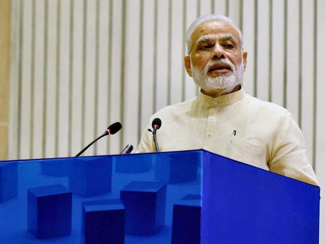 Prime Minister Narendra Modi delivers a speech in New Delhi. Modi will visit Gujarat on Tuesday to inaugurate the SAUNI project. (PTI File Photo) Prime Minister Narendra Modi delivers a speech in New Delhi. Modi will visit Gujarat on Tuesday to inaugurate the SAUNI project. (PTI File Photo)