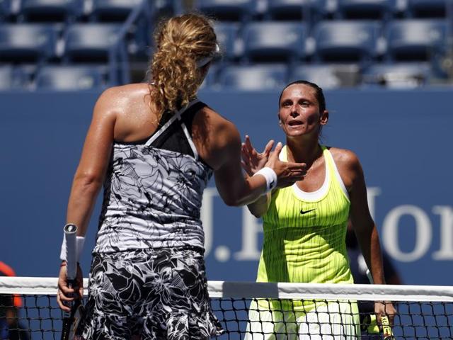 Roberta Vinci, of Italy, right, greets Anna-Lena Friedsam, of Germany, after winning their first round match. (AP Photo) 