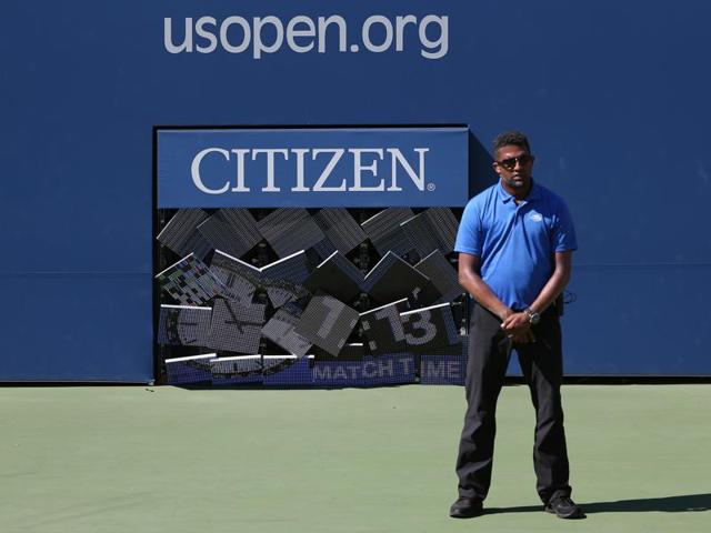 An official stands waiting for a fallen match clock board to be fixed inside Court 17 during the match between Gael Monfils, of France, and Gilles Muller, of Luxembourg.(AP)