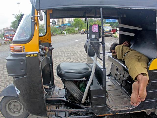 An auto rickshaw driver sleeps away at Lokmanya Tilak Terminus for Wednesday was no-duty day for him. (Satyabrata Tripathy/ht photo)