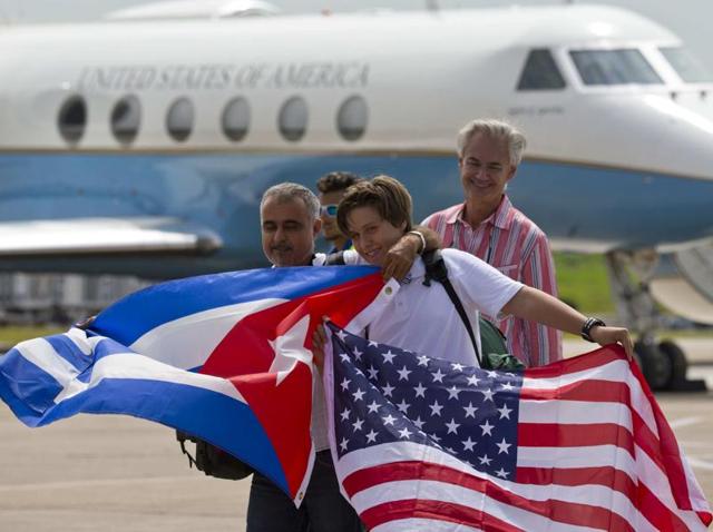 Passengers of JetBlue flight 387 hold United States and Cuban national flags at an airport in Santa Clara, Cuba. (AP) Passengers of JetBlue flight 387 hold United States and Cuban national flags at an airport in Santa Clara, Cuba. (AP)