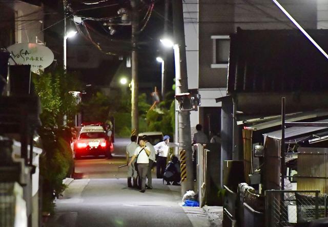 Plainclothes police walk around an area where Yasuhide Mizobata, a murder suspect, was found in Wakayama, central Japan, Wednesday, Aug. 31, 2016. Mizobata, a suspect in a fatal shooting, holes up at an apartment in an armed standoff after he fired at a police car and escaped. (AP) Plainclothes police walk around an area where Yasuhide Mizobata, a murder suspect, was found in Wakayama, central Japan, Wednesday, Aug. 31, 2016. Mizobata, a suspect in a fatal shooting, holes up at an apartment in an armed standoff after he fired at a police car and escaped. (AP)
