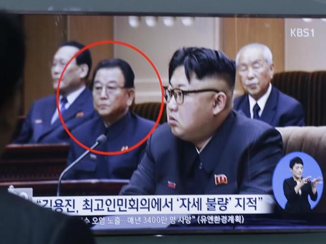 A TV screen shows a file image of Kim Yong Jin, second from left, a vice premier on education affairs in North Korea's cabinet, and North Korean leader Kim Jong Un, second from right. (AP) A TV screen shows a file image of Kim Yong Jin, second from left, a vice premier on education affairs in North Korea's cabinet, and North Korean leader Kim Jong Un, second from right. (AP)