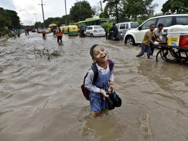Heavy showers on Wednesday morning inundated vast swathes of the national capital region. Delhi received 65.7mm rainfall in the morning, leading to traffic jams and harassed commuters. A school girl sees the bright side of wading through a flooded road near Turkman Gate in New Delhi. (Arun Sharma/HT PHOTO) Heavy showers on Wednesday morning inundated vast swathes of the national capital region. Delhi received 65.7mm rainfall in the morning, leading to traffic jams and harassed commuters. A school girl sees the bright side of wading through a flooded road near Turkman Gate in New Delhi. (Arun Sharma/HT PHOTO)
