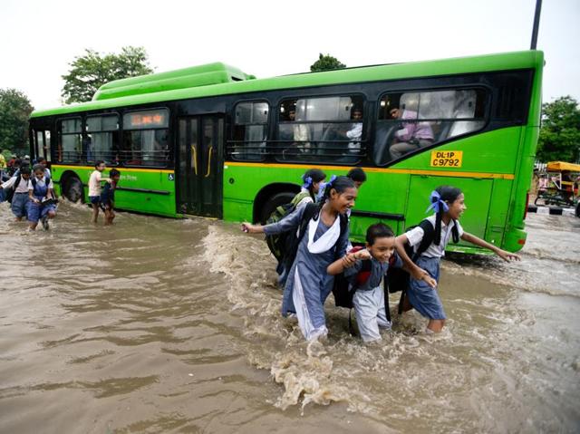School was probably called off ; that’s why these students are smiling as they wade a flooded road in Delhi. (Arun Sharma/HT PHOTO) School was probably called off ; that’s why these students are smiling as they wade a flooded road in Delhi. (Arun Sharma/HT PHOTO)