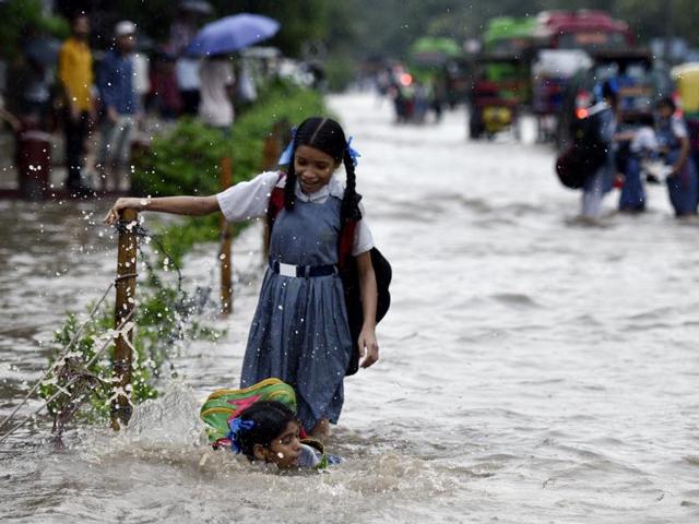 Many roads in Delhi were flooded in the rain. Visiting US diplomat John Kerry quipped, ‘did people need boats’ in Delhi. These school girls at Turkman Gate may have asked the same (Arun Sharma/HT PHOTO) Many roads in Delhi were flooded in the rain. Visiting US diplomat John Kerry quipped, ‘did people need boats’ in Delhi. These school girls at Turkman Gate may have asked the same (Arun Sharma/HT PHOTO)