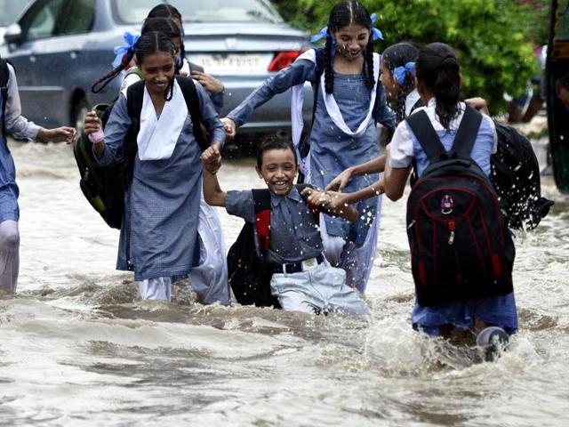 This group of school students made the most of walking through a flooded road in central Delhi. (Arun Sharma/HT PHOTO) This group of school students made the most of walking through a flooded road in central Delhi. (Arun Sharma/HT PHOTO)