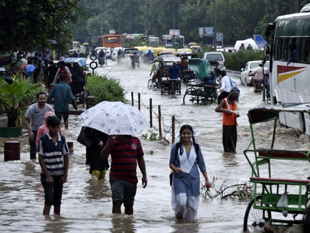 Near Turkman Gate in New Delhi, people didn’t let the rain stop their daily lives. (Arun Sharma/HT PHOTO) Near Turkman Gate in New Delhi, people didn’t let the rain stop their daily lives. (Arun Sharma/HT PHOTO)