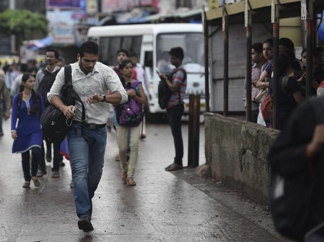 A man runs to catch BEST bus outside Kurlla station (West) as auto rickshaws in the city go off roads in protest against app-based cabs on Wednesday. (Arijit Sen/ht photo)