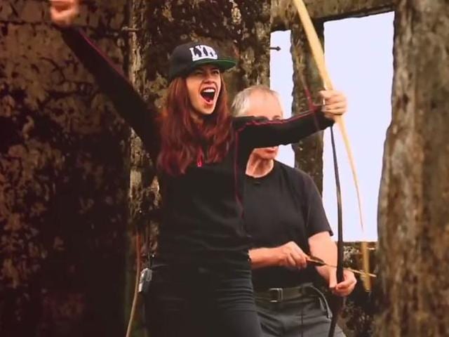 Here she is enjoying a game of archery with her father. (YouTube)