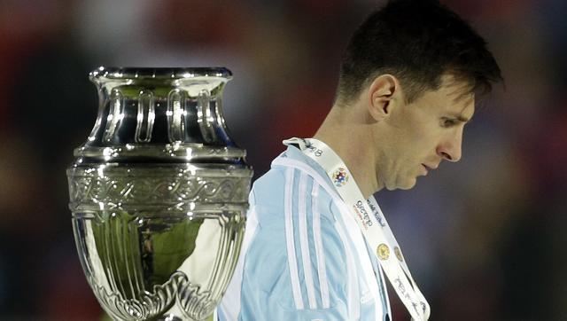 Messi walks by the Copa America trophy after receiving the runners-up medal. (AP) Messi walks by the Copa America trophy after receiving the runners-up medal. (AP)