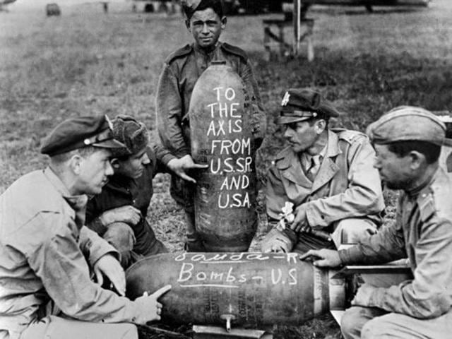 Airmen from the USA and the Soviet Union prepare a joint message, reading "To the axis, from USSR and USA” to the Nazi enemy at an airbase in Russia. American aircraft have used bases in Russia since June 1944, when flying fortresses and fighter planes took off from a base in Italy, bombed German targets in Bucharest and continued to new airfields in Russia prepared to receive them. (AFP Archive)