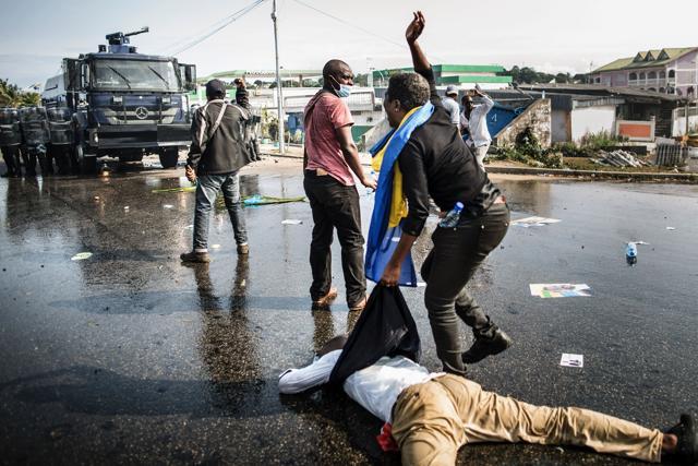 A wounded supporter of Gabonese opposition leader Jean Ping lies on the ground in Libreville. (AFP Photo)